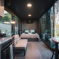 Modern tiny home with kitchen, dining area, and bedroom in a compact design.